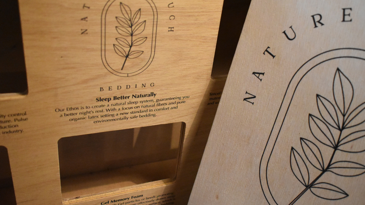 Photography of wooden point of sale with printed branding.