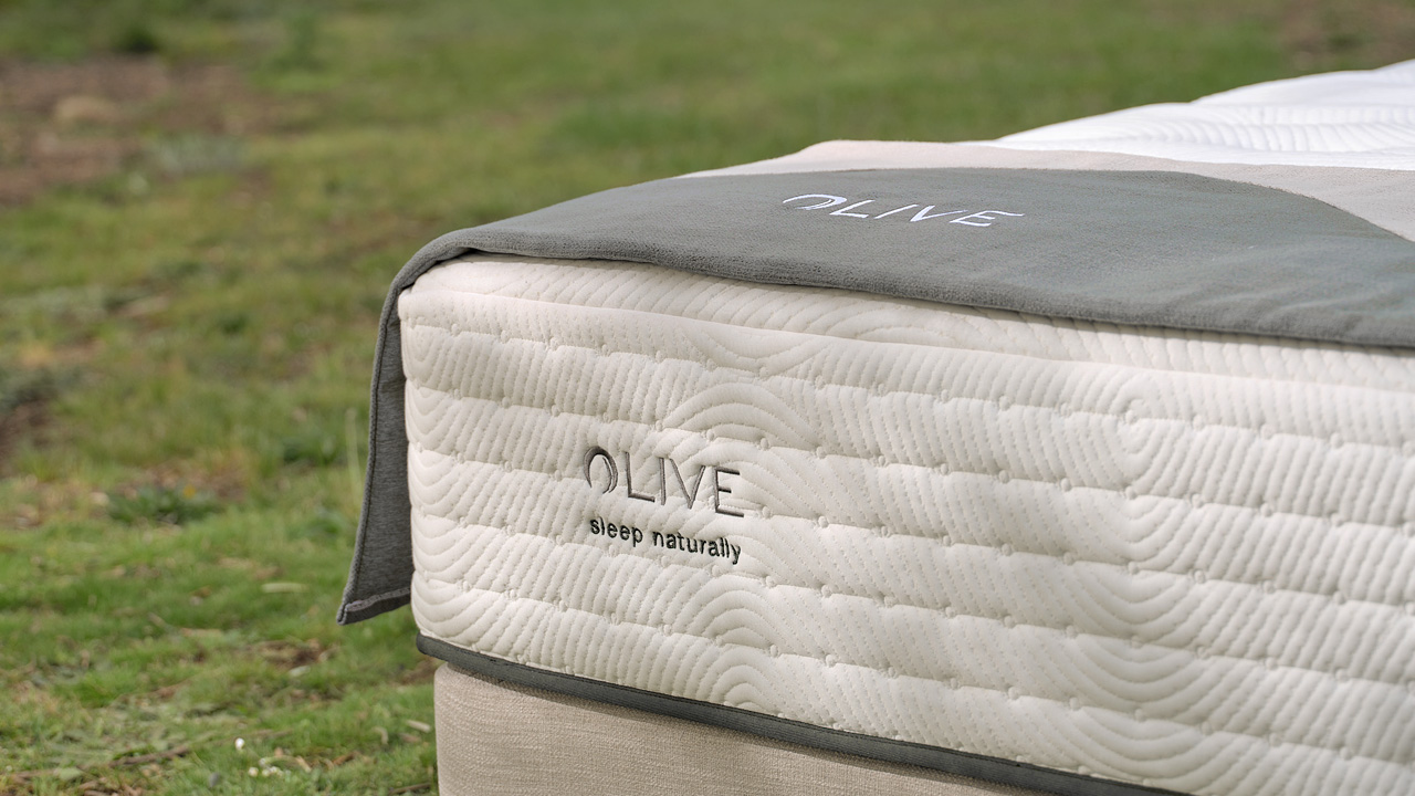 Shot of Olive mattress and upholstered foot protector.