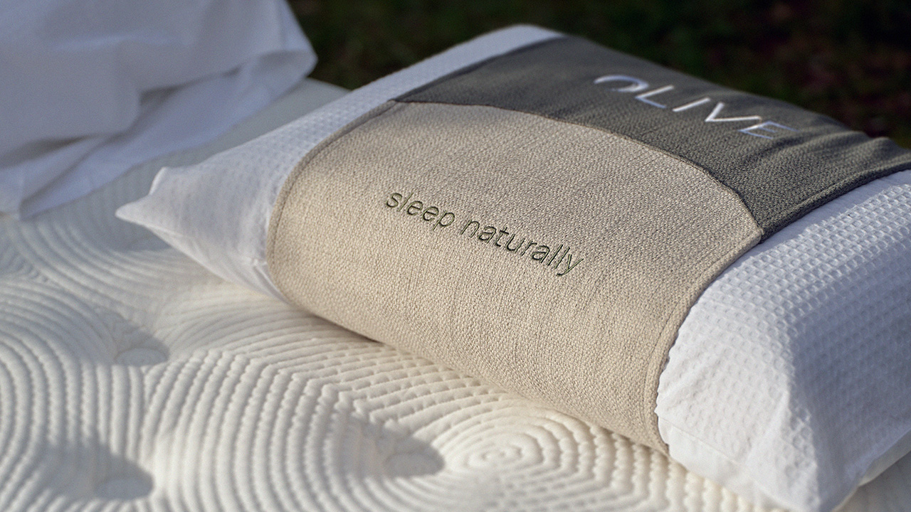 Upholstered and embroidered Olive Pillow Wrap on Olive mattress.