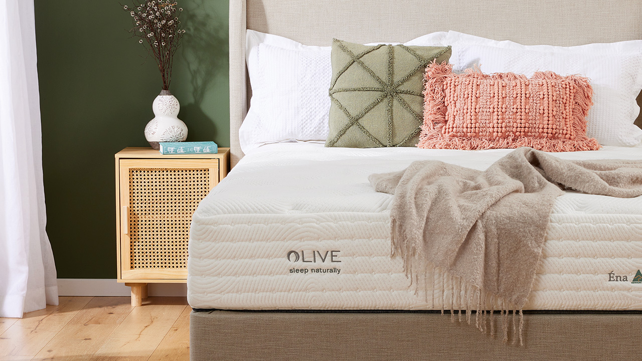Dressed room shot of Olive mattress.